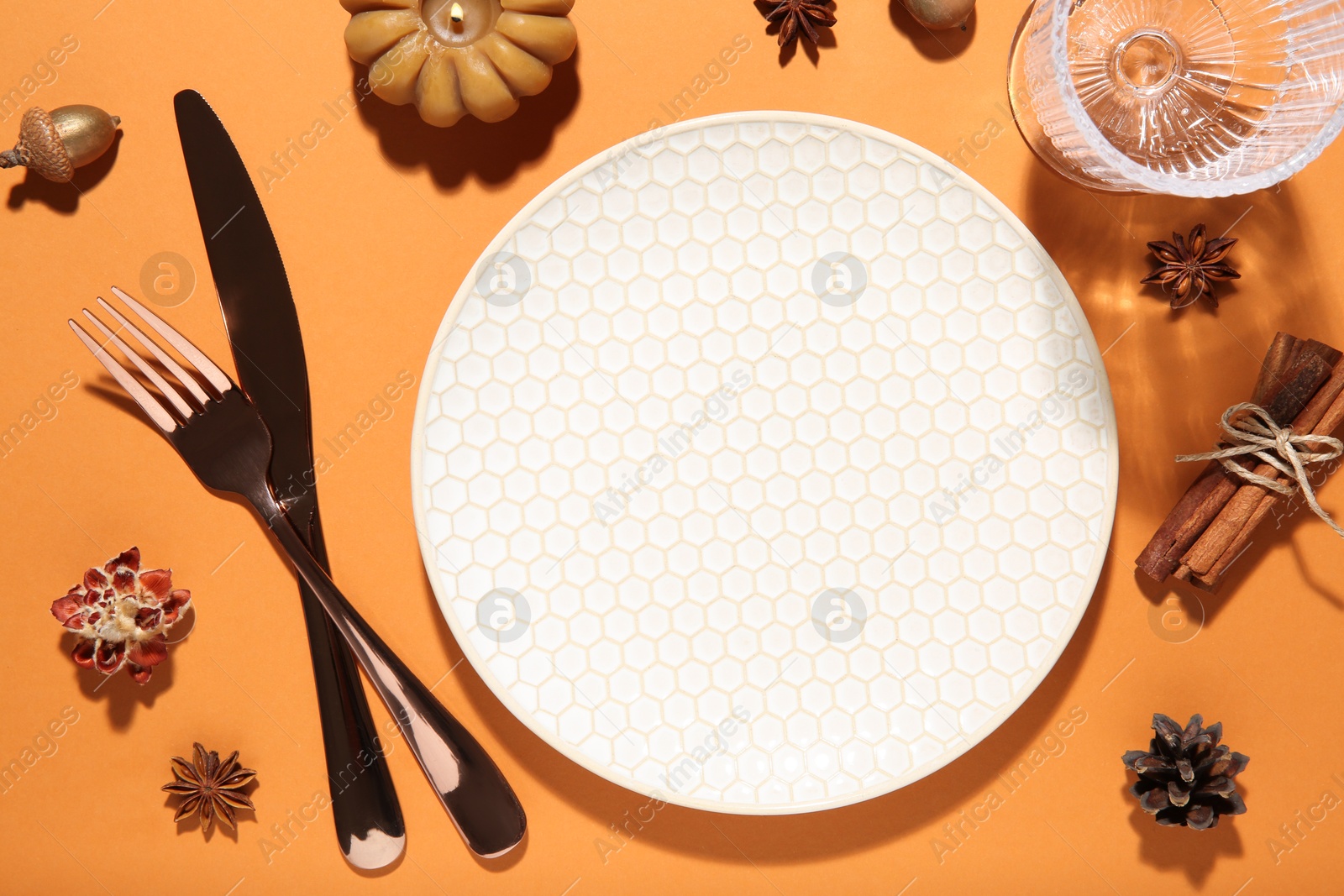 Photo of Beautiful table setting with autumn decor on orange background, flat lay