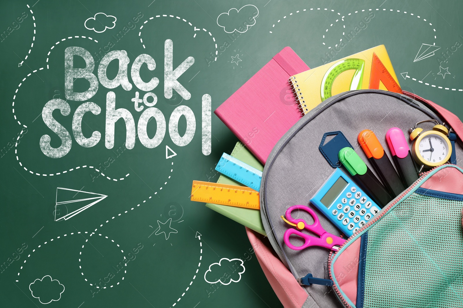 Image of Backpack with stationery on green chalkboard, top view. Back to school