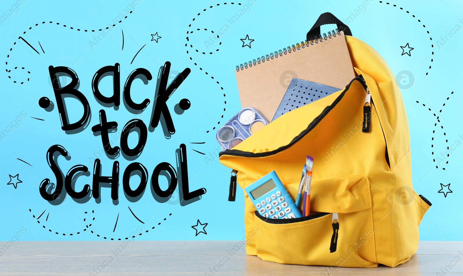 Image of Backpack with stationery on desk against light blue background. Back to school