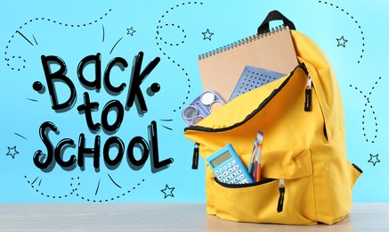 Image of Backpack with stationery on desk against light blue background. Back to school