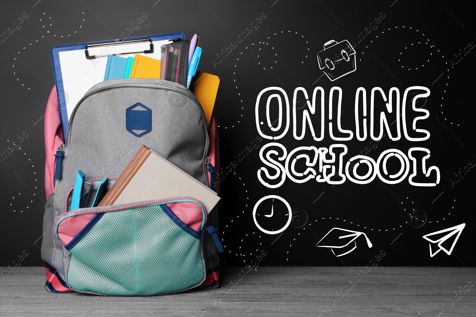 Image of Backpack with stationery on desk near chalkboard with text Online School