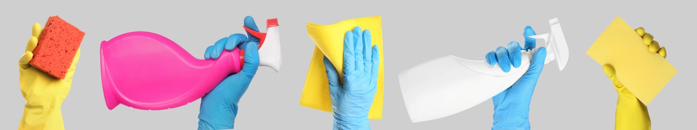 Image of Janitors holding different cleaning supplies on light grey background, closeup