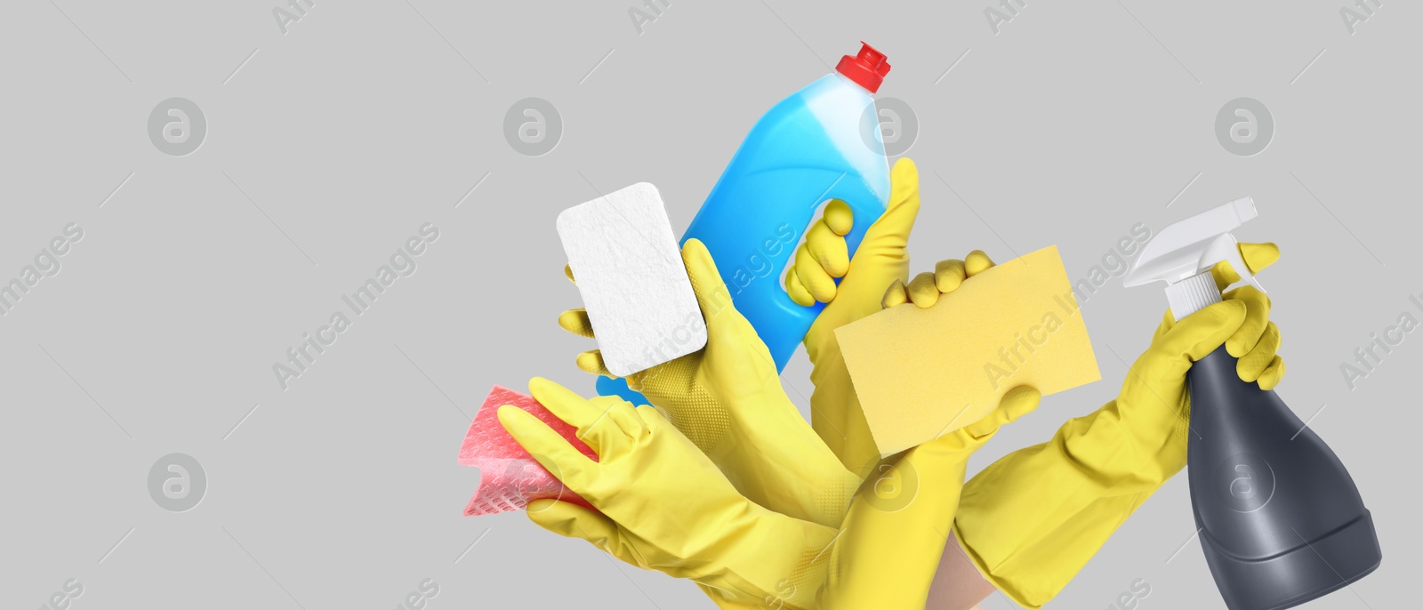 Image of Janitors holding different cleaning supplies on grey background, closeup. Banner design with space for text