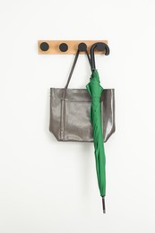 Photo of Green umbrella and bag on rack in hallway