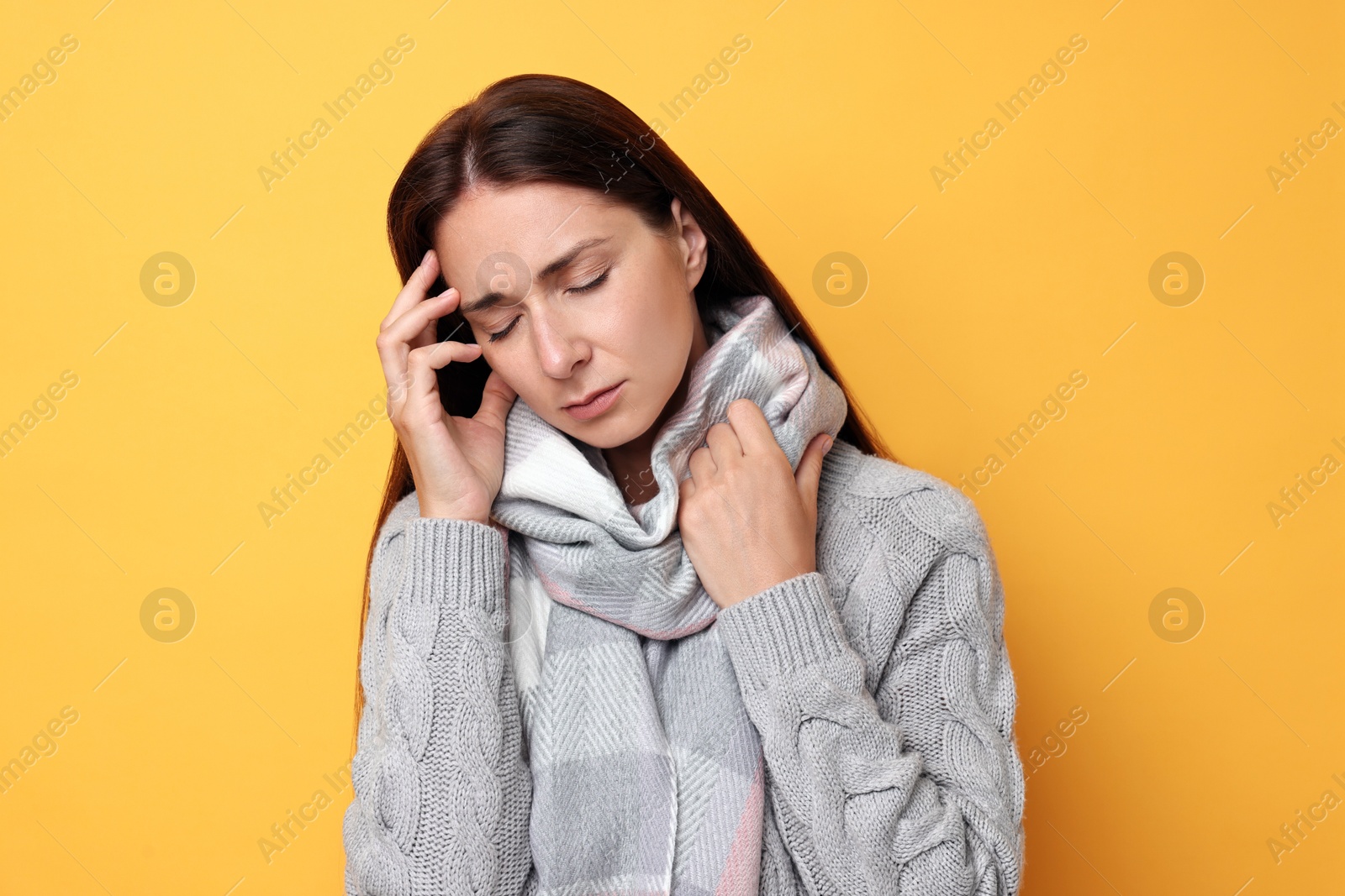 Photo of Sick woman suffering from cold symptoms on orange background