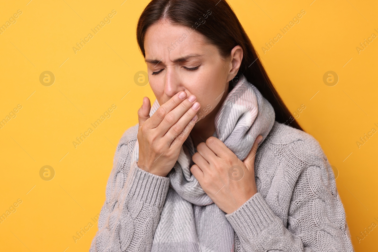 Photo of Sick woman suffering from cold symptoms on orange background