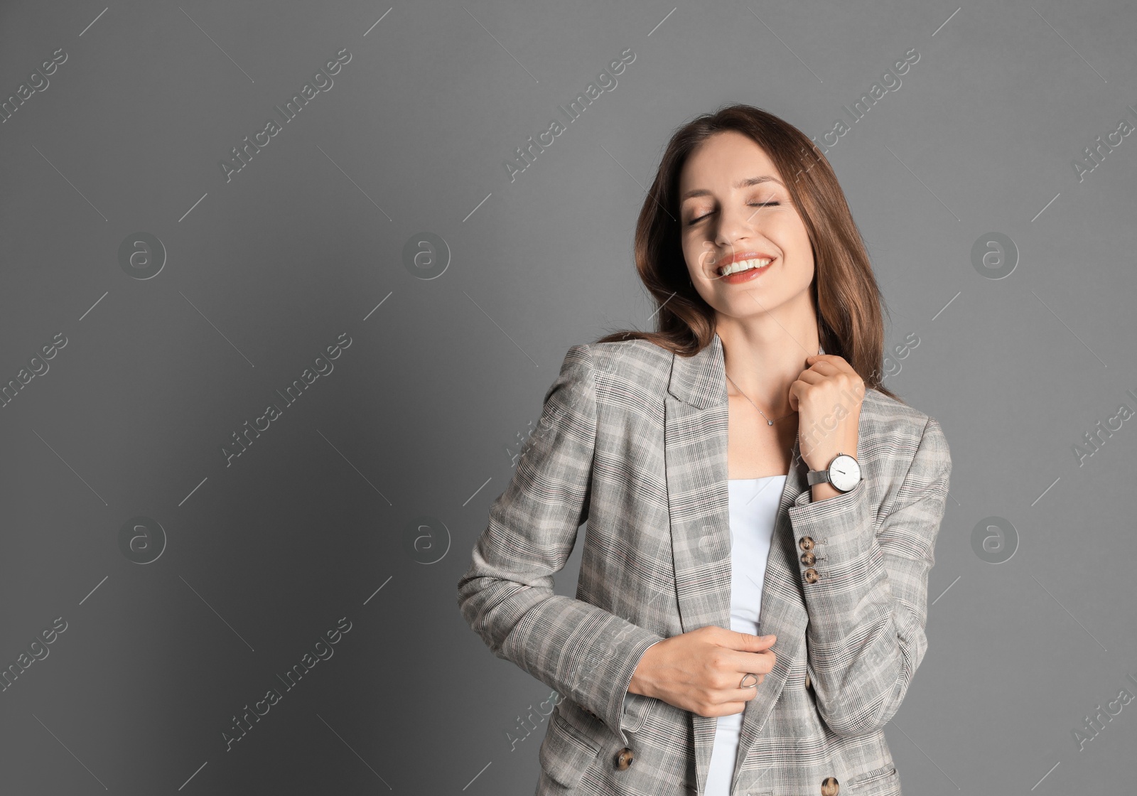 Photo of Beautiful woman in stylish jacket on grey background. Space for text