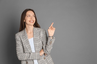 Photo of Beautiful woman in stylish jacket on grey background. Space for text