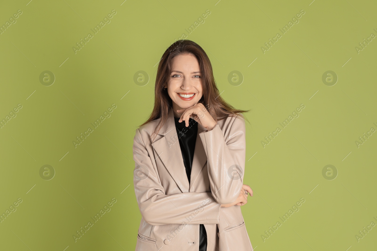 Photo of Beautiful woman in stylish beige jacket on olive background