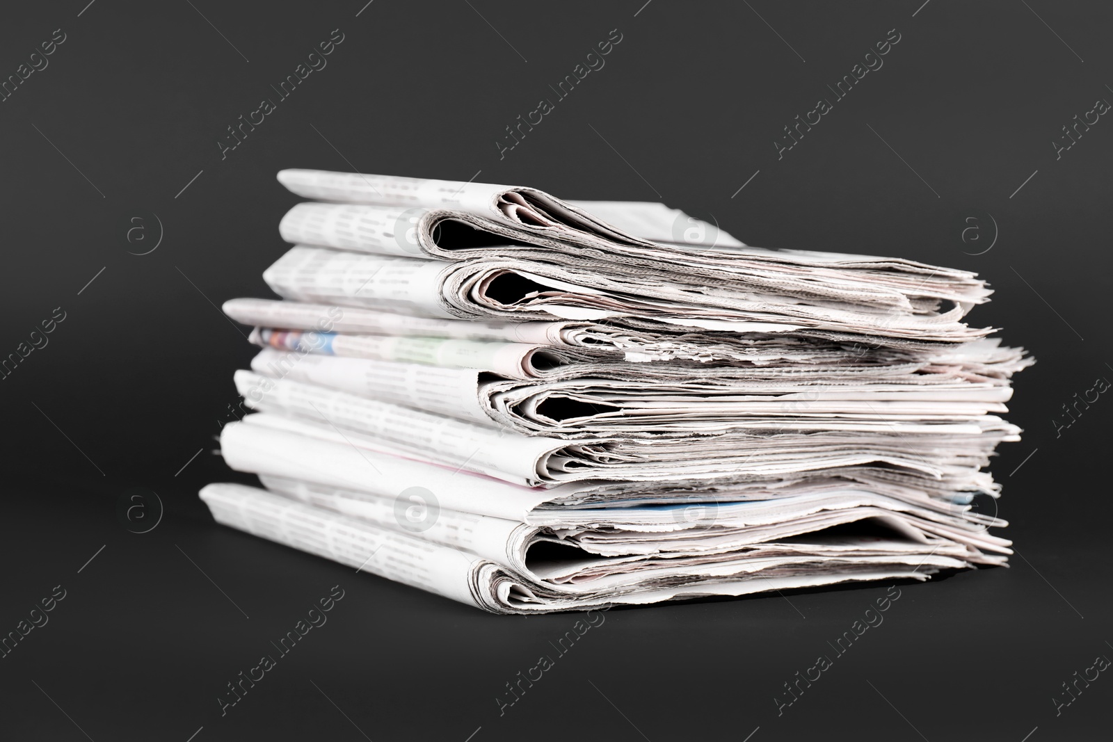 Photo of Stack of many newspapers on grey background