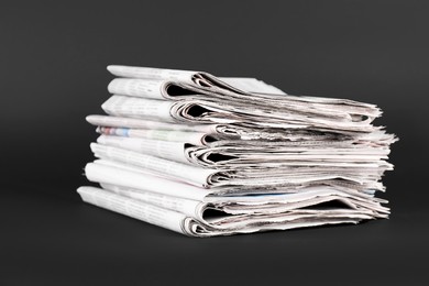 Photo of Stack of many newspapers on grey background