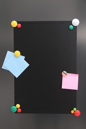 Photo of Black magnetic board and notes on refrigerator