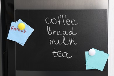 Magnetic board with shopping list and notes on refrigerator