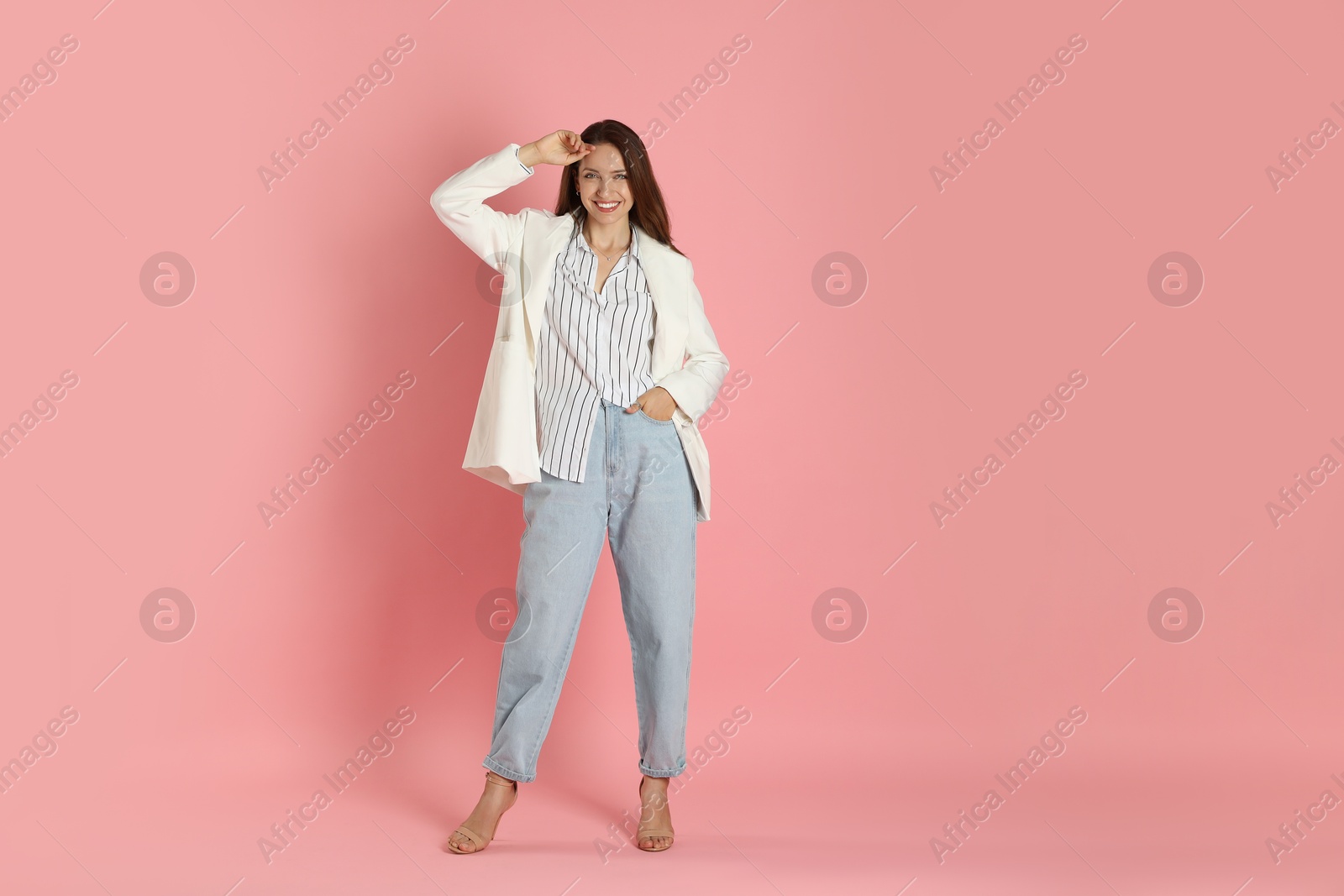 Photo of Beautiful woman in stylish white jacket on pink background, space for text