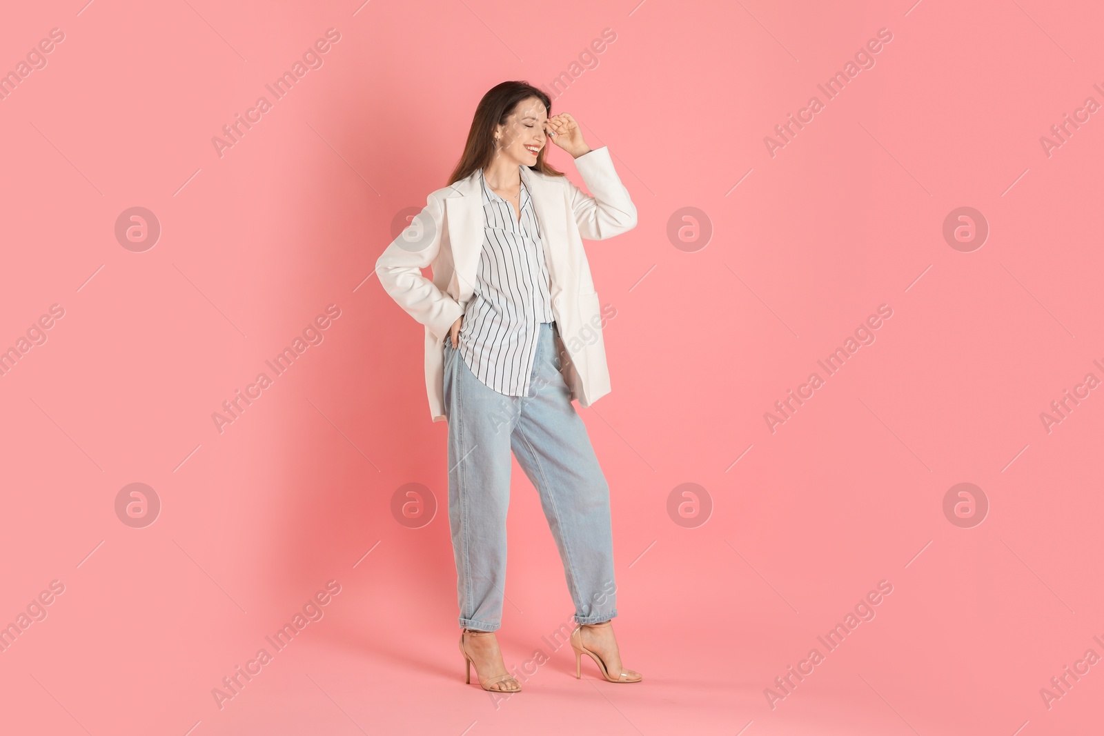 Photo of Beautiful woman in stylish white jacket on pink background