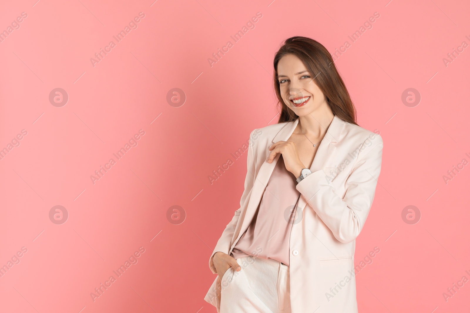 Photo of Beautiful woman in stylish white suit on pink background, space for text