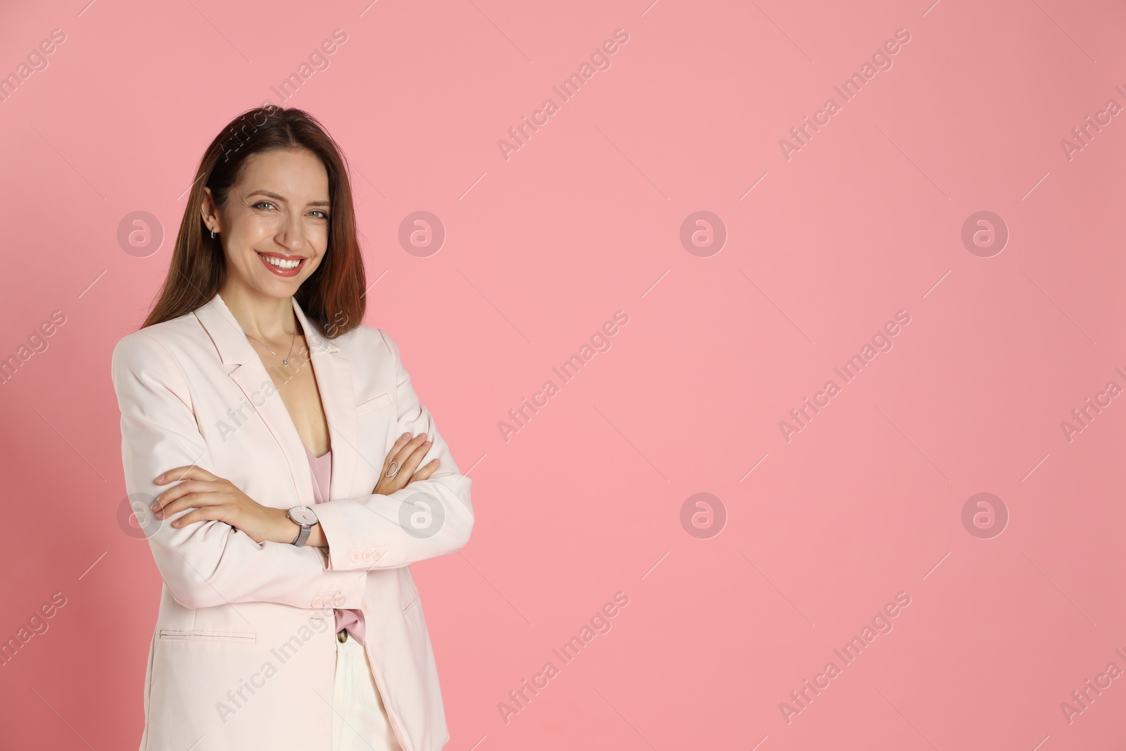 Photo of Beautiful woman in stylish white suit on pink background, space for text