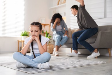 Photo of Divorce concept. Angry couple arguing at home, focus on their sad daughter