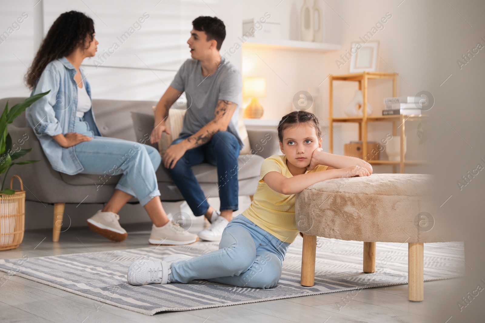 Photo of Divorce concept. Angry couple arguing at home, focus on their sad daughter