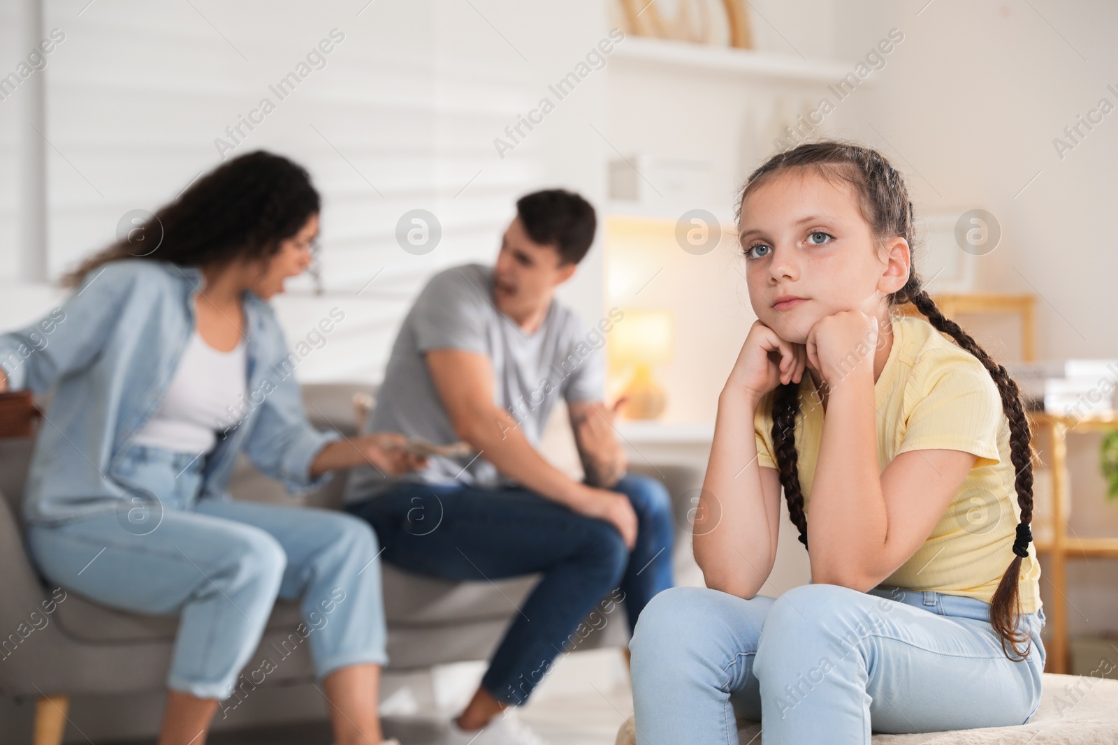 Photo of Divorce concept. Angry couple arguing at home, focus on their sad daughter