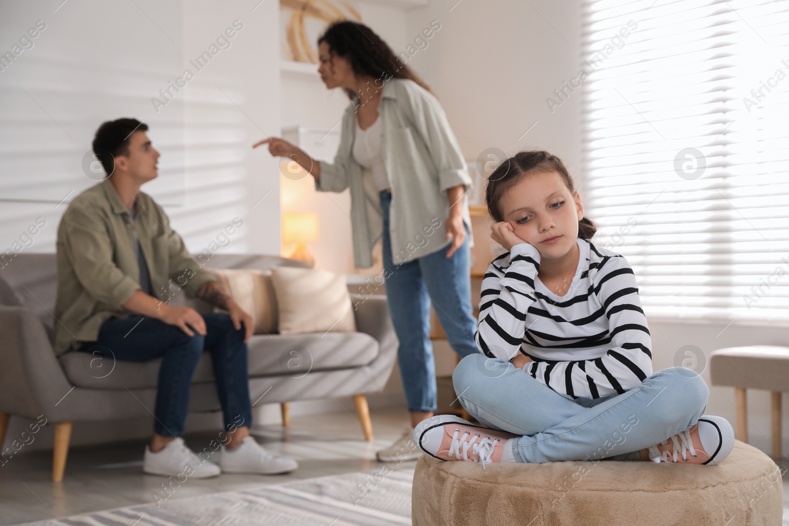 Photo of Divorce concept. Angry couple arguing at home, focus on their sad daughter