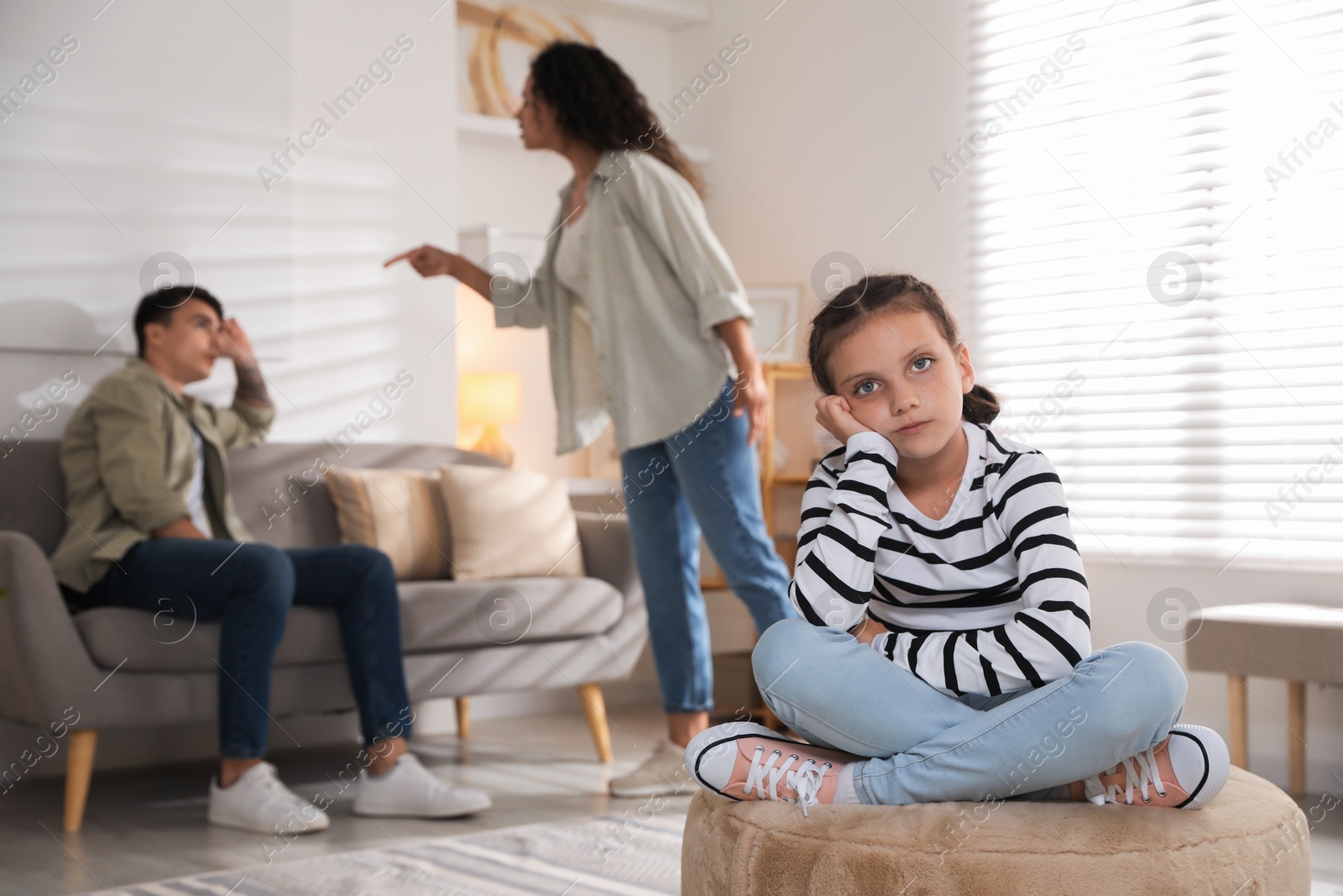 Photo of Divorce concept. Angry couple arguing at home, focus on their sad daughter