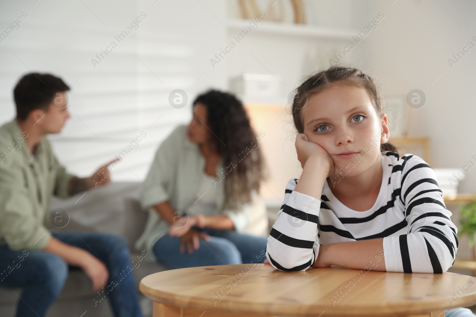 Photo of Divorce concept. Angry couple arguing at home, focus on their sad daughter