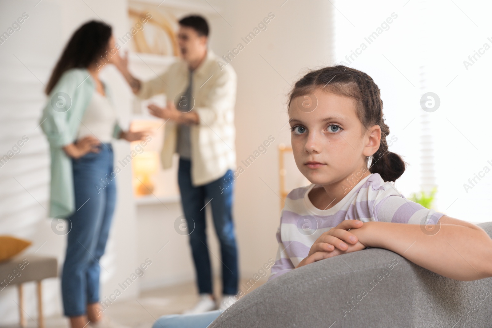 Photo of Divorce concept. Angry couple arguing at home, focus on their sad daughter