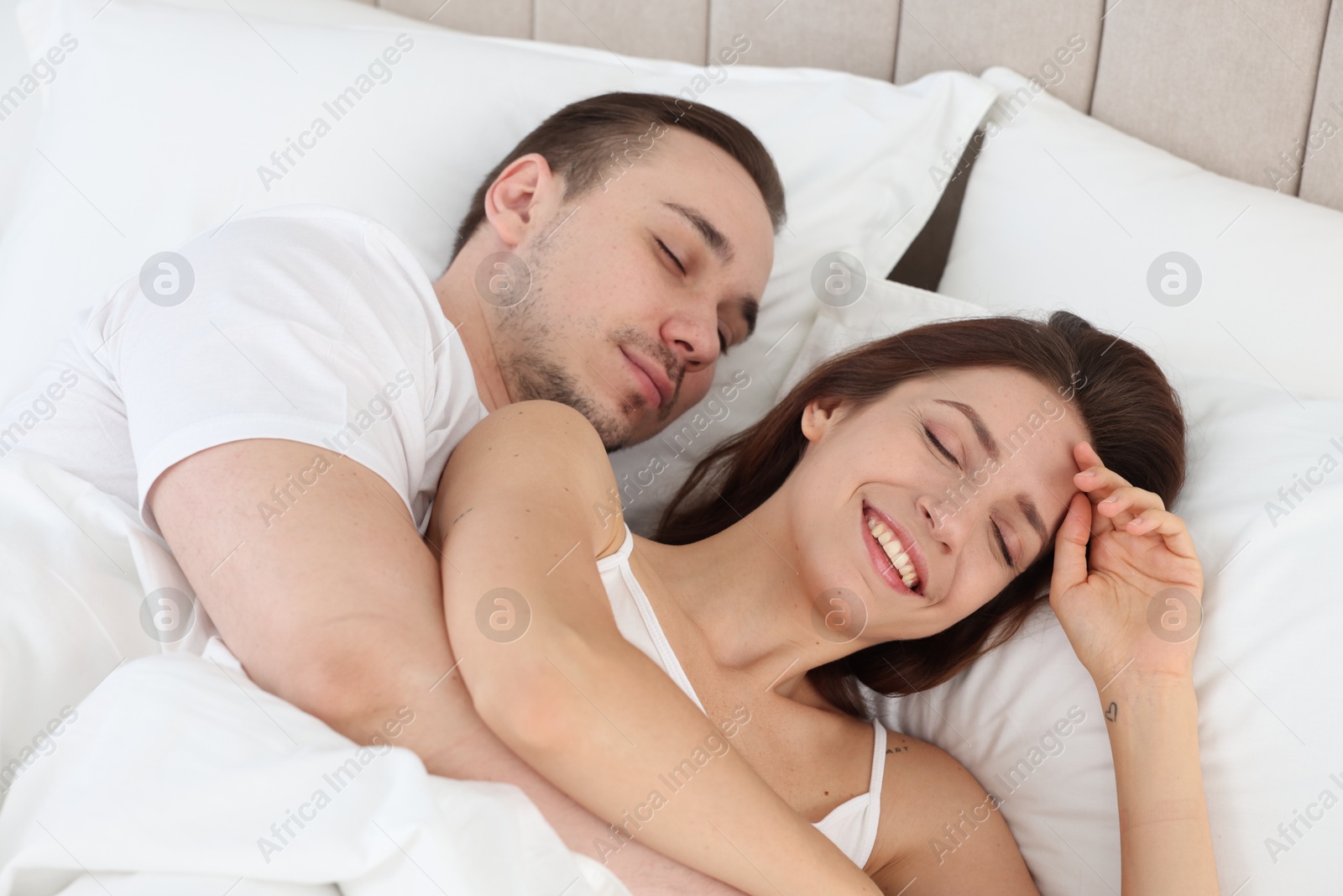 Photo of Cute couple lying in bed at home