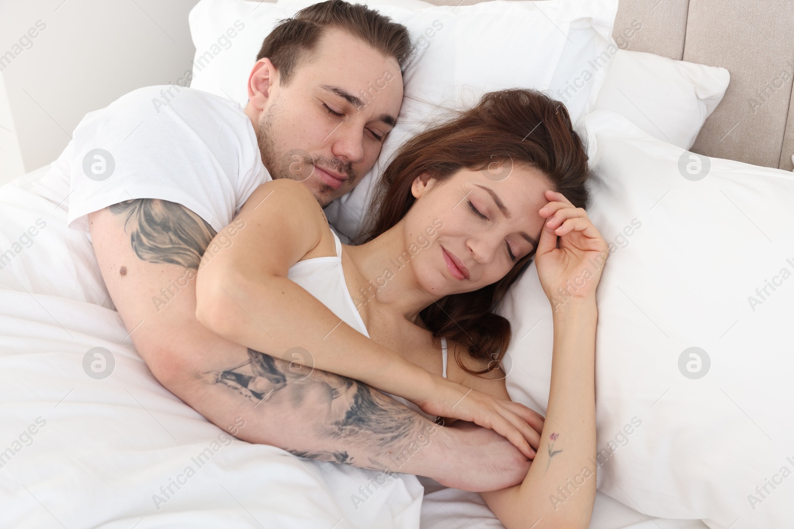 Photo of Cute couple napping in bed at home