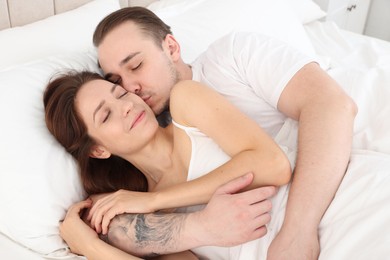 Photo of Cute couple napping in bed at home