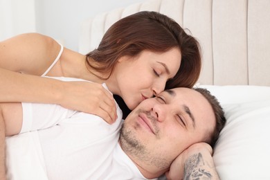 Happy couple spending time together on bed at home