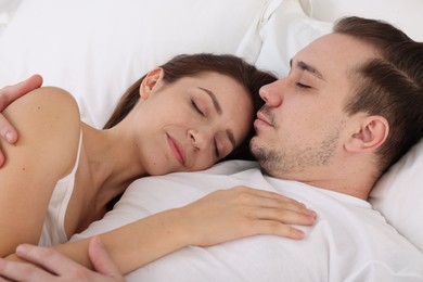 Photo of Cute couple napping on bed at home