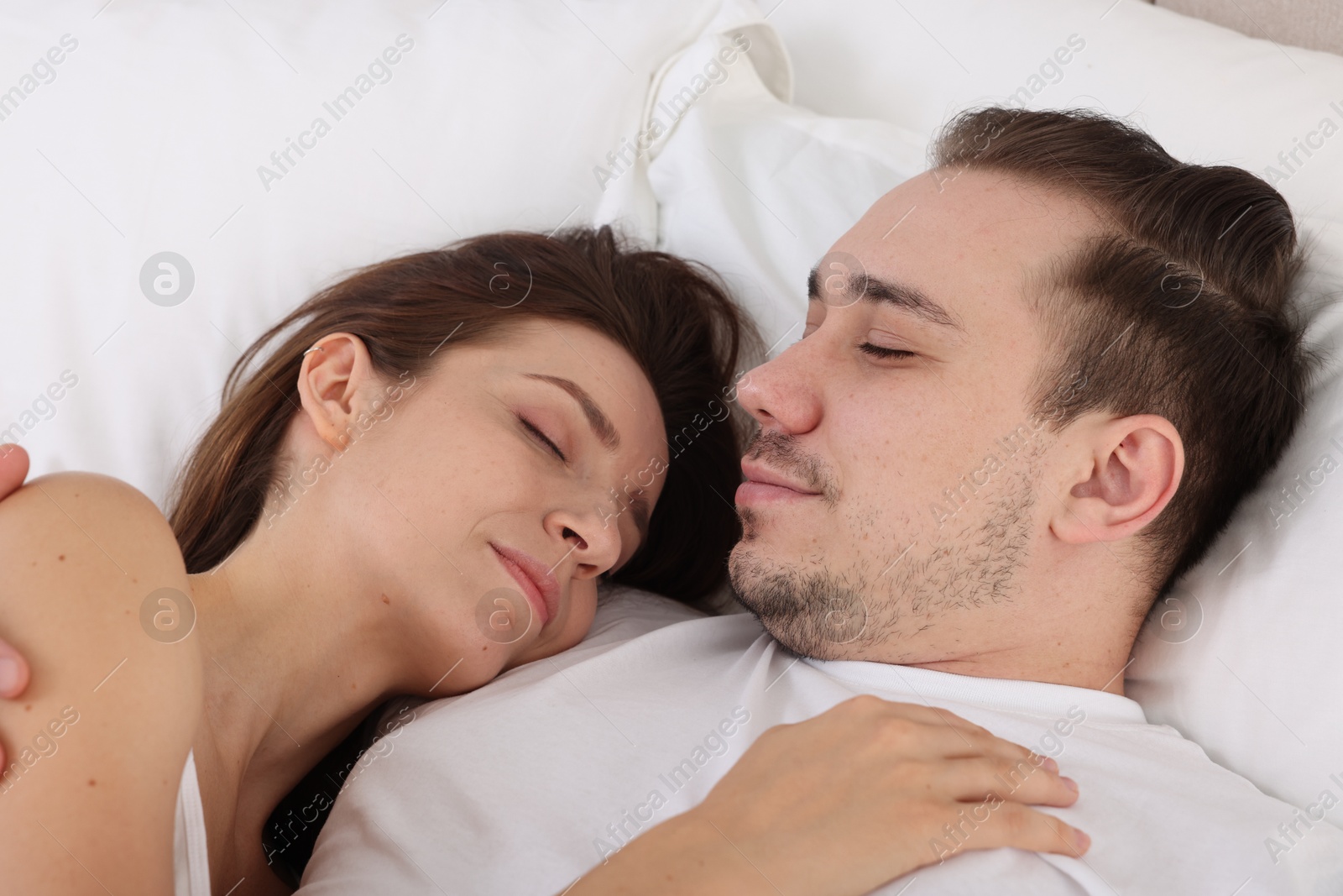 Photo of Cute couple napping on bed at home