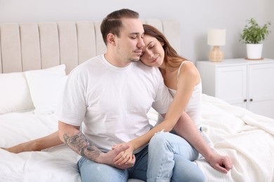 Photo of Cute couple spending time together on bed at home