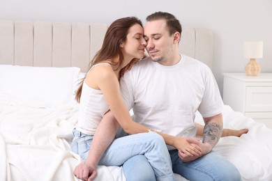 Photo of Cute couple spending time together on bed at home