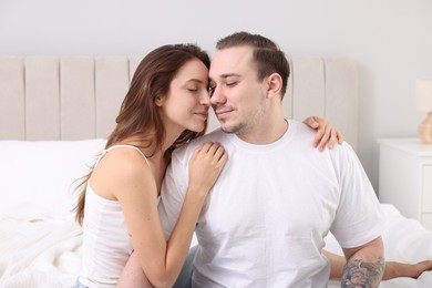 Cute couple spending time together on bed at home