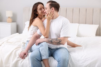 Happy couple spending time together on bed at home