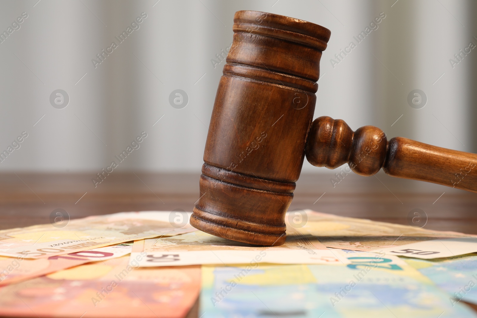 Photo of Alimony. Judge's gavel and pile of money on table, closeup