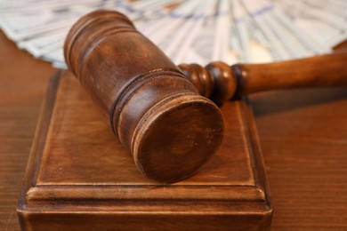 Alimony. Judge's gavel and sound block on wooden table, closeup