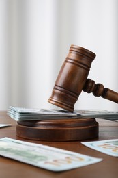 Alimony. Money, judge's gavel and sound block on wooden table, closeup