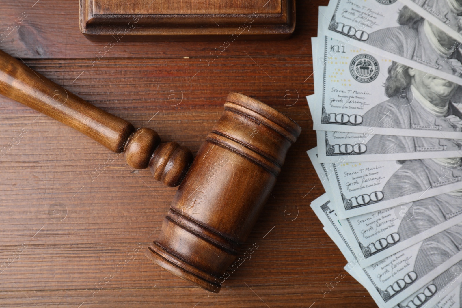 Photo of Alimony. Money, judge's gavel and sound block on wooden table, flat lay