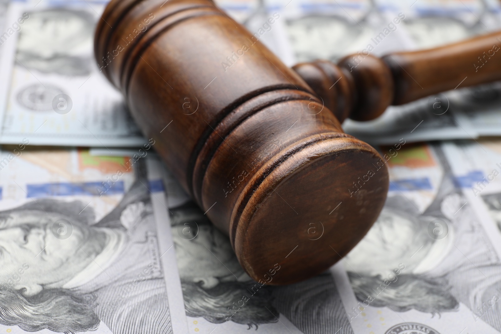 Photo of Alimony. Judge's gavel on dollar banknotes, closeup