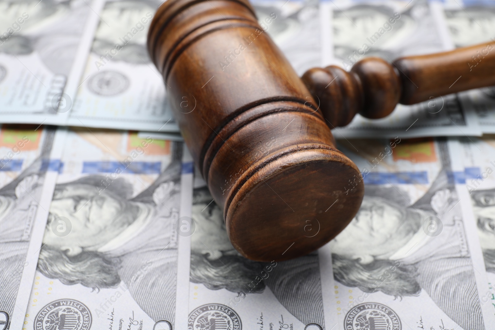 Photo of Alimony. Judge's gavel on dollar banknotes, closeup