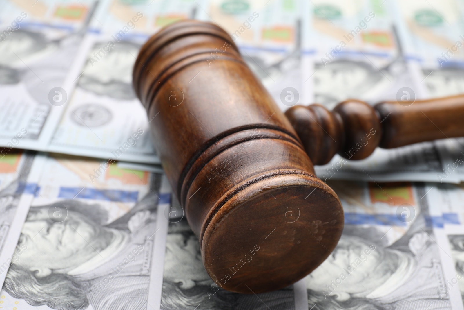 Photo of Alimony. Judge's gavel on dollar banknotes, closeup