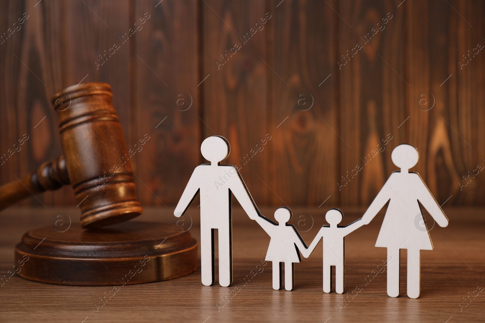 Photo of Alimony. Figures of family and gavel on wooden table