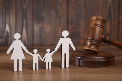 Photo of Alimony. Figures of family and gavel on wooden table