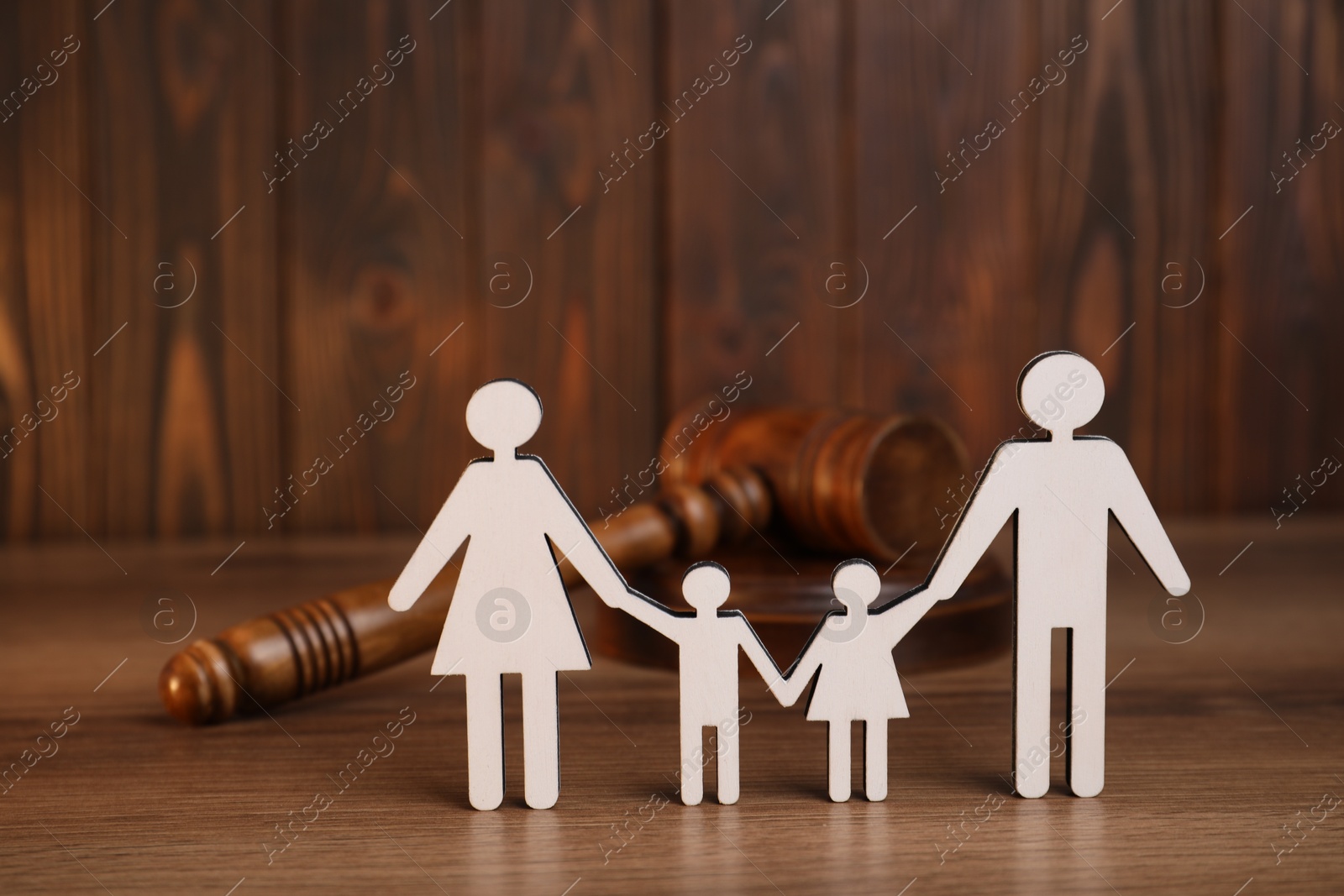 Photo of Alimony. Figures of family and gavel on wooden table