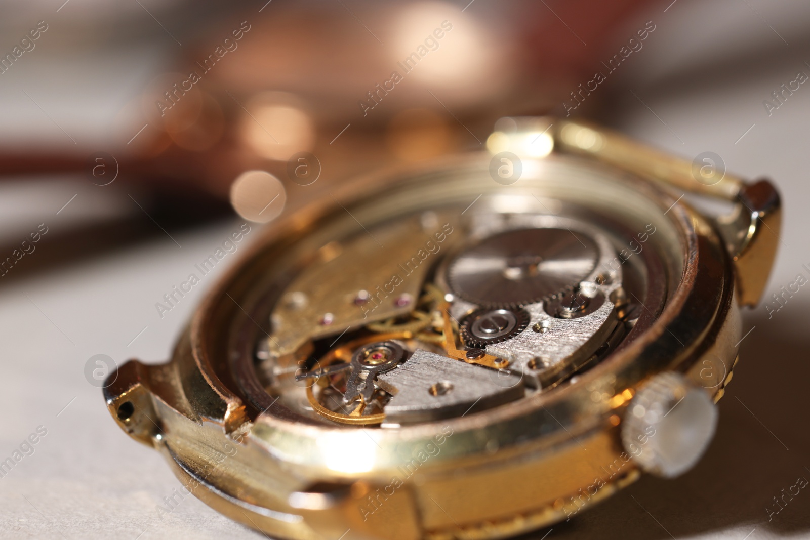 Photo of Mechanism of vintage wrist watch on light table, closeup