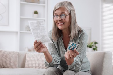 Senior woman with pills reading medicine instruction at home